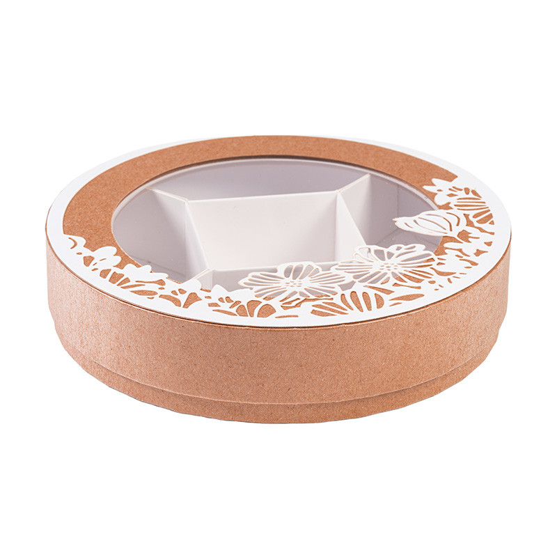 Shirley "Florilège" : Boîte ronde Shirley de la collection "Florilège" avec fenêtre transparente, parfaite pour présenter chocolats et gourmandises de Pâques avec style et poésie.